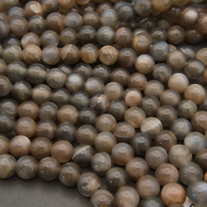 Close-up of brown and gray beads on a dark background