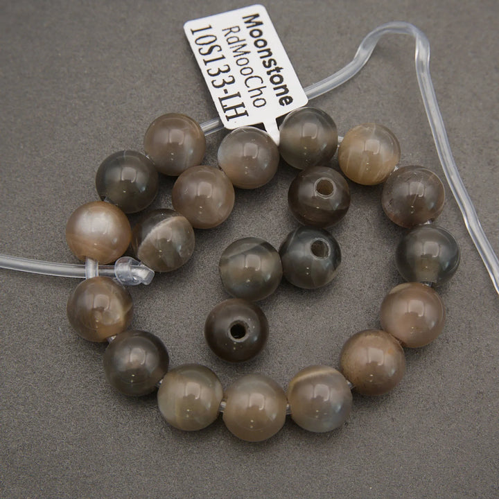 String of brown beads with a label on a gray background