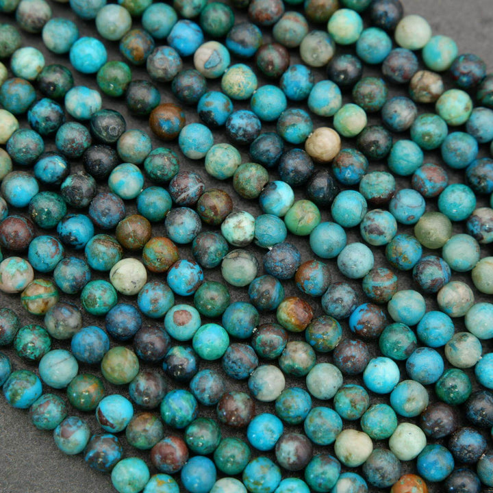 Close-up of blue and green beads on a dark background