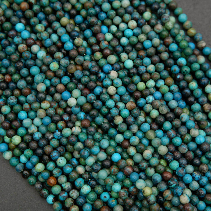 Close-up of blue and green beads on a dark background