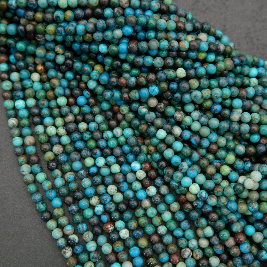 Close-up of blue and green beads on a gray surface