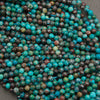 A heap of microfaceted chrysocolla bead strands in blue green with brown matrix