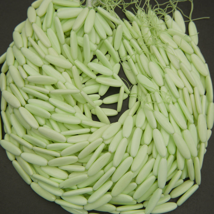 Close-up of a ball of light green yarn on a dark background