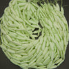 Close-up of a ball of light green yarn on a dark background