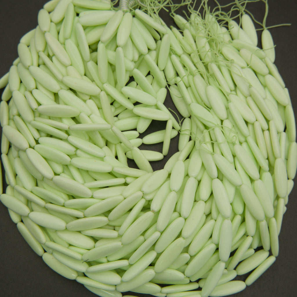 Close-up of a ball of light green yarn on a dark background