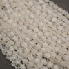 A heap of faceted clear quartz star bead strands in frosty white and water clear with silver seed bead spacers