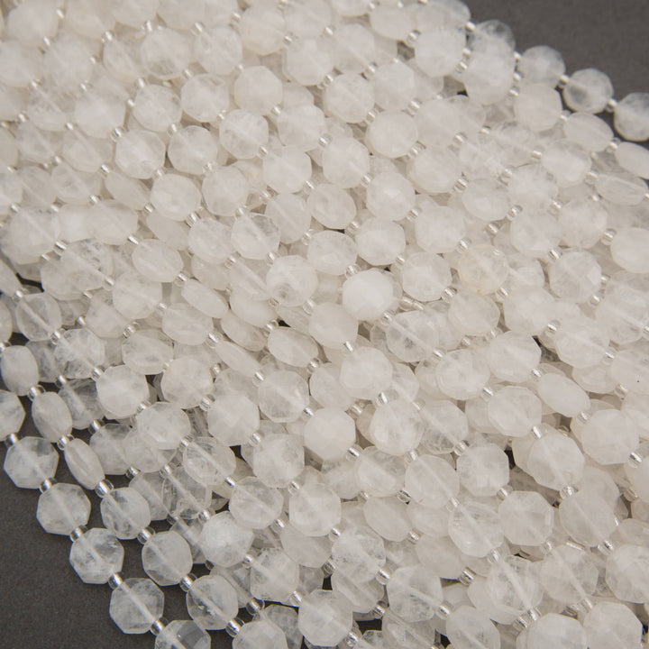 Natural clear quartz gemstone beads featuring elegant octagonal shapes and delicate internal veining.