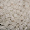 Close-up of faceted clear quartz beads displaying geometric octagonal cuts and frosty white coloration.