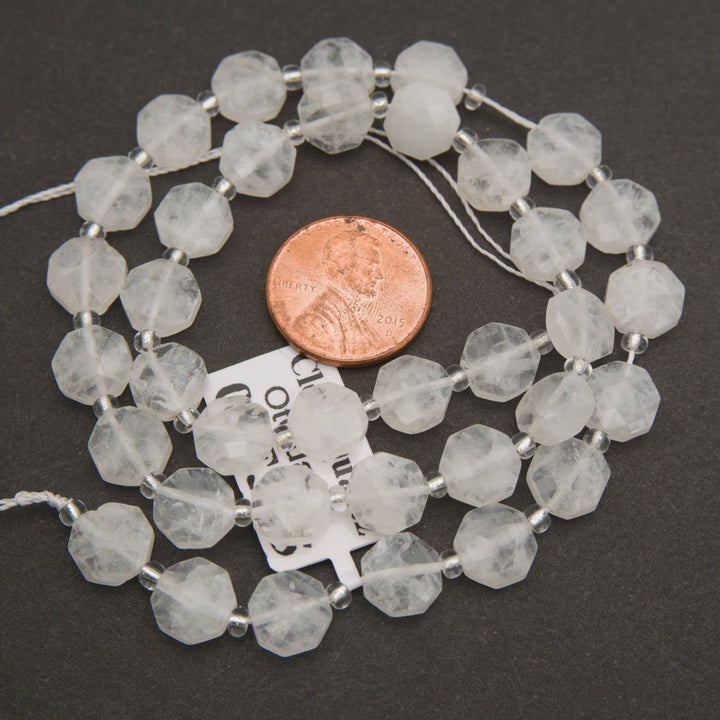 Strands of clear quartz octagon gemstone beads with natural internal patterns and silver spacer beads.