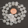 Strands of clear quartz octagon gemstone beads with natural internal patterns and silver spacer beads.