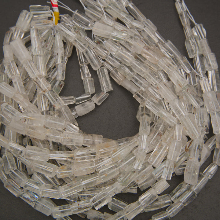 Natural rock crystal quartz tube beads with polished surfaces and distinctive elongated rectangular shapes for jewelry making.