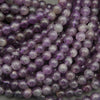 Close-up of purple beads on a gray background
