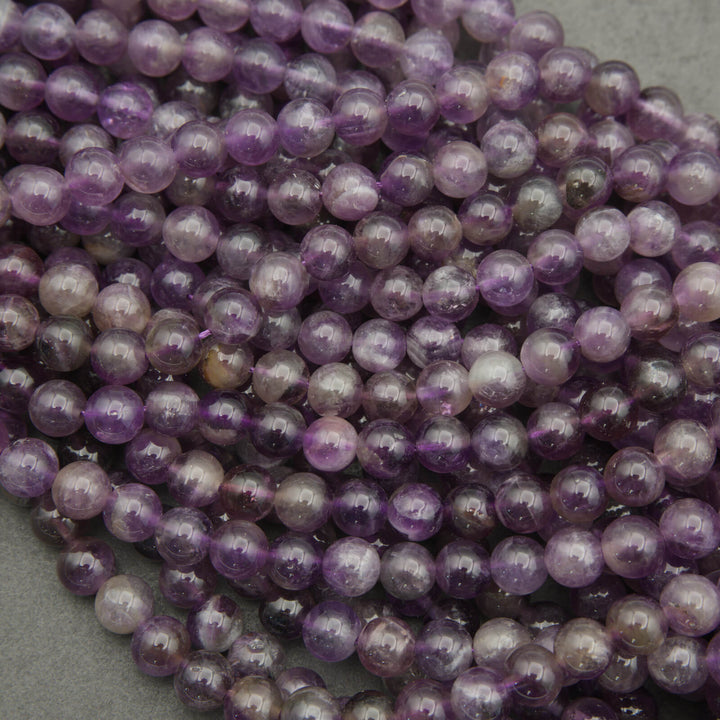 Close-up of a string of purple beads on a gray background