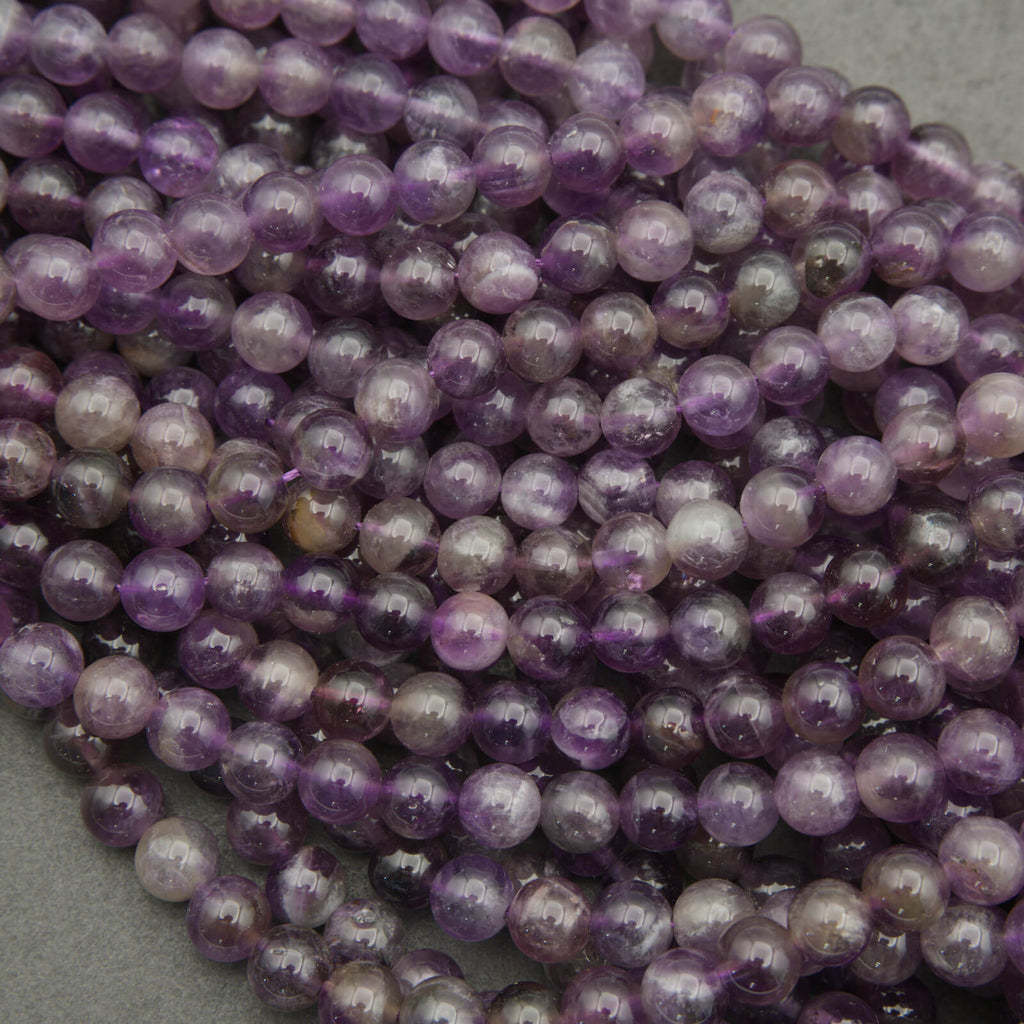 Close-up of a string of purple beads on a gray background