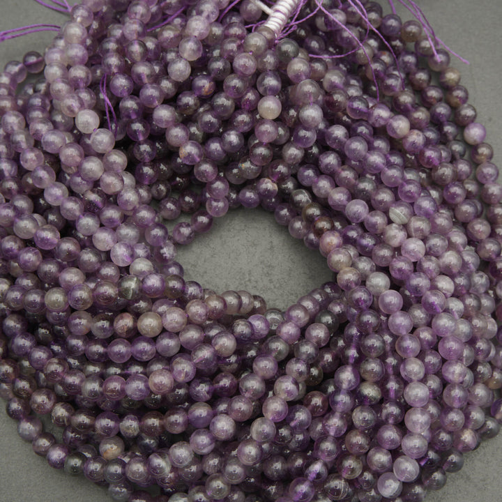 String of purple beads on a gray background