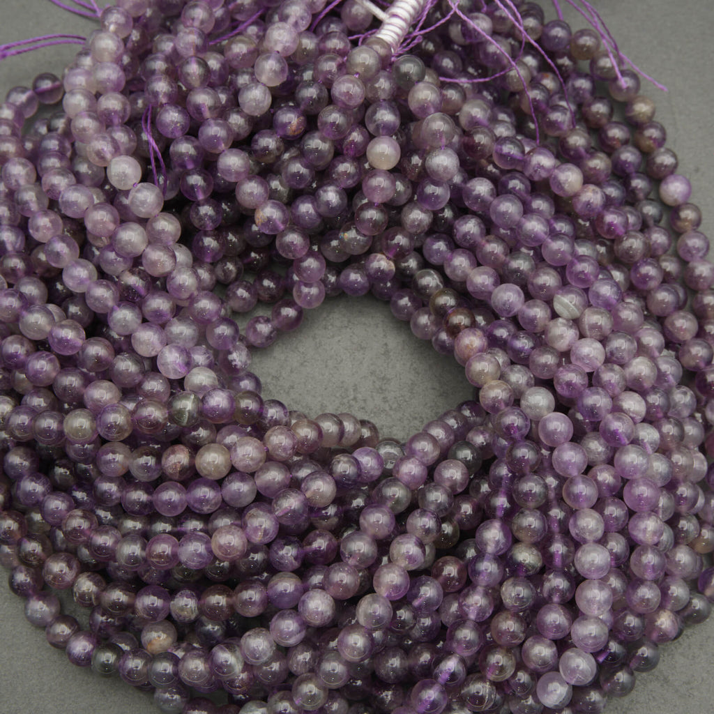 String of purple beads on a gray background