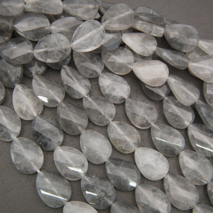 Cloudy clear twisted oval beads.