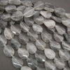 Cloudy clear twisted oval beads.