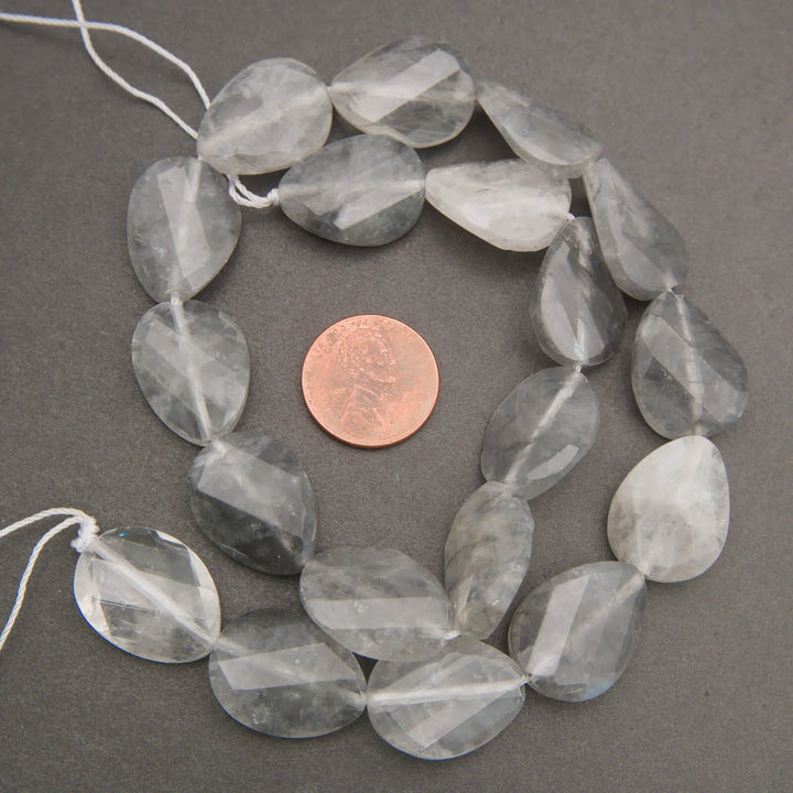 Cloudy clear twisted oval beads.