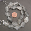 Cloudy clear twisted oval beads.