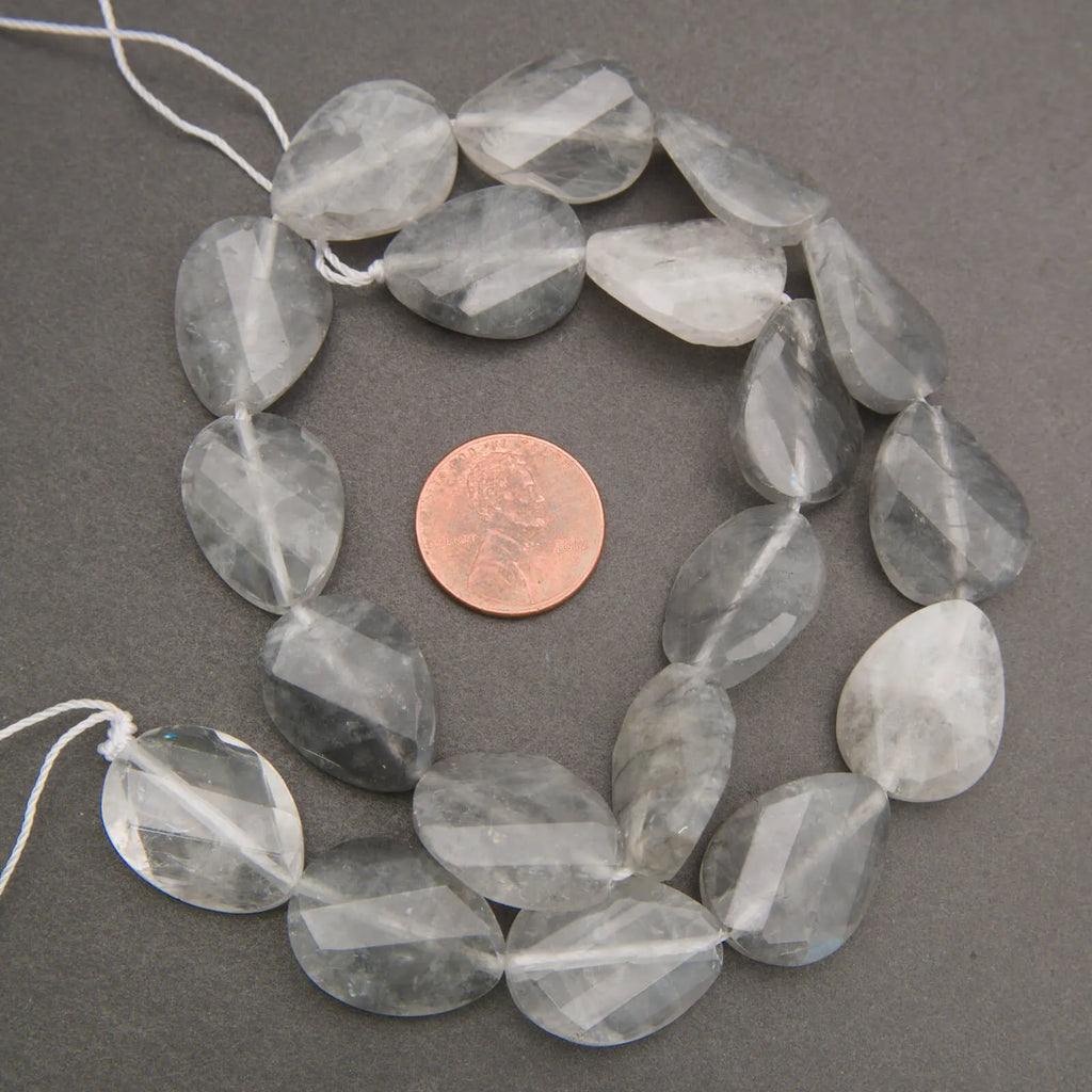 Cloudy clear twisted oval beads.