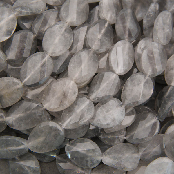 Cloudy clear twisted oval beads.