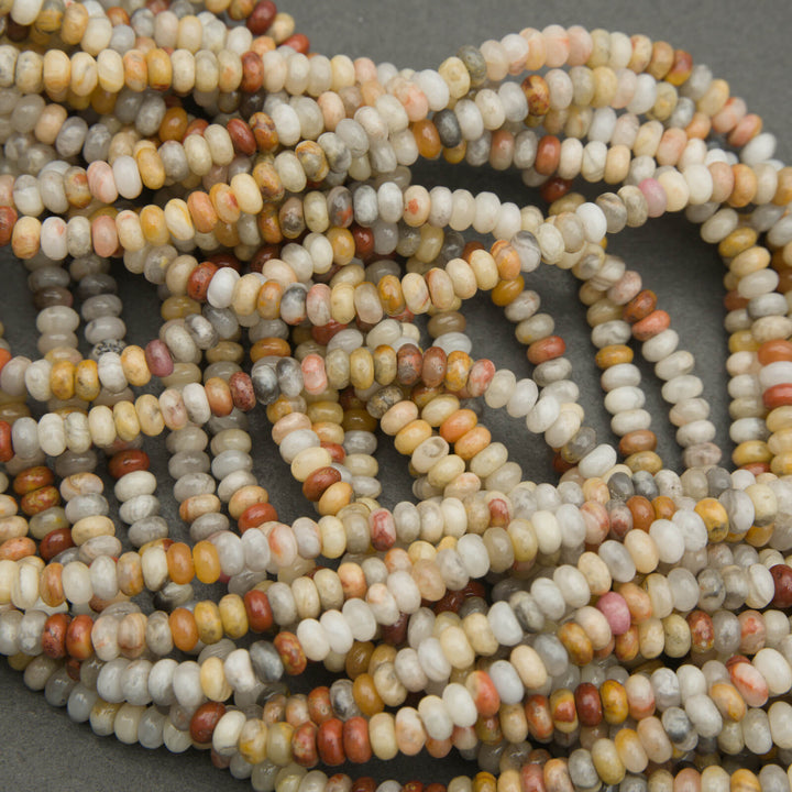 Close-up of a string of multicolored beads on a gray background