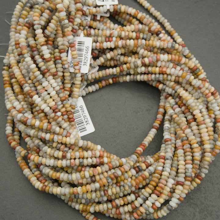 Multicolored bead string on a gray background with a visible barcode label.