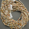 Multicolored bead string on a gray background with a visible barcode label.