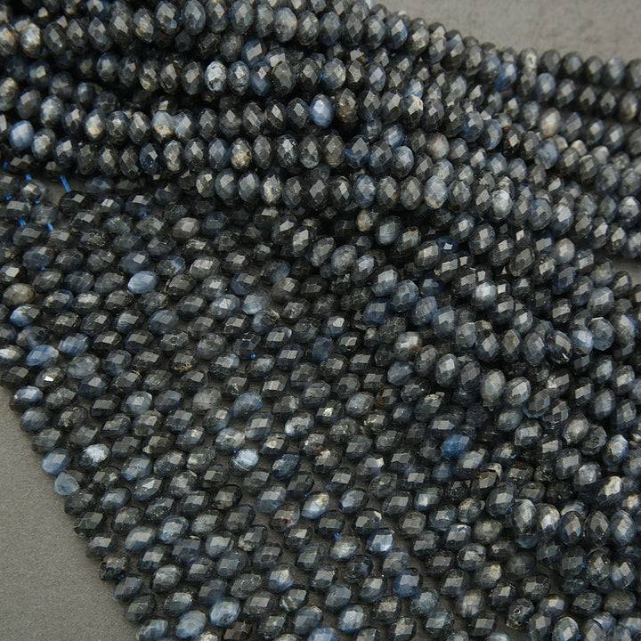 Close-up of dark blue faceted beads on a gray background