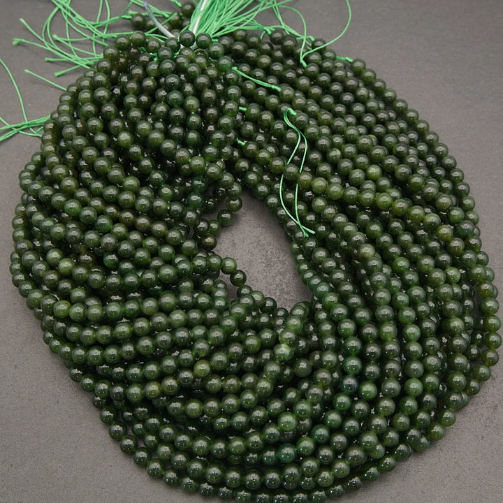 Green beaded necklace on a gray background