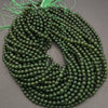 Green beaded necklace on a gray background