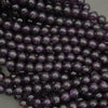 Close-up of purple beads on a gray background