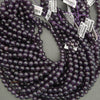 String of purple beads with price tags on a gray surface