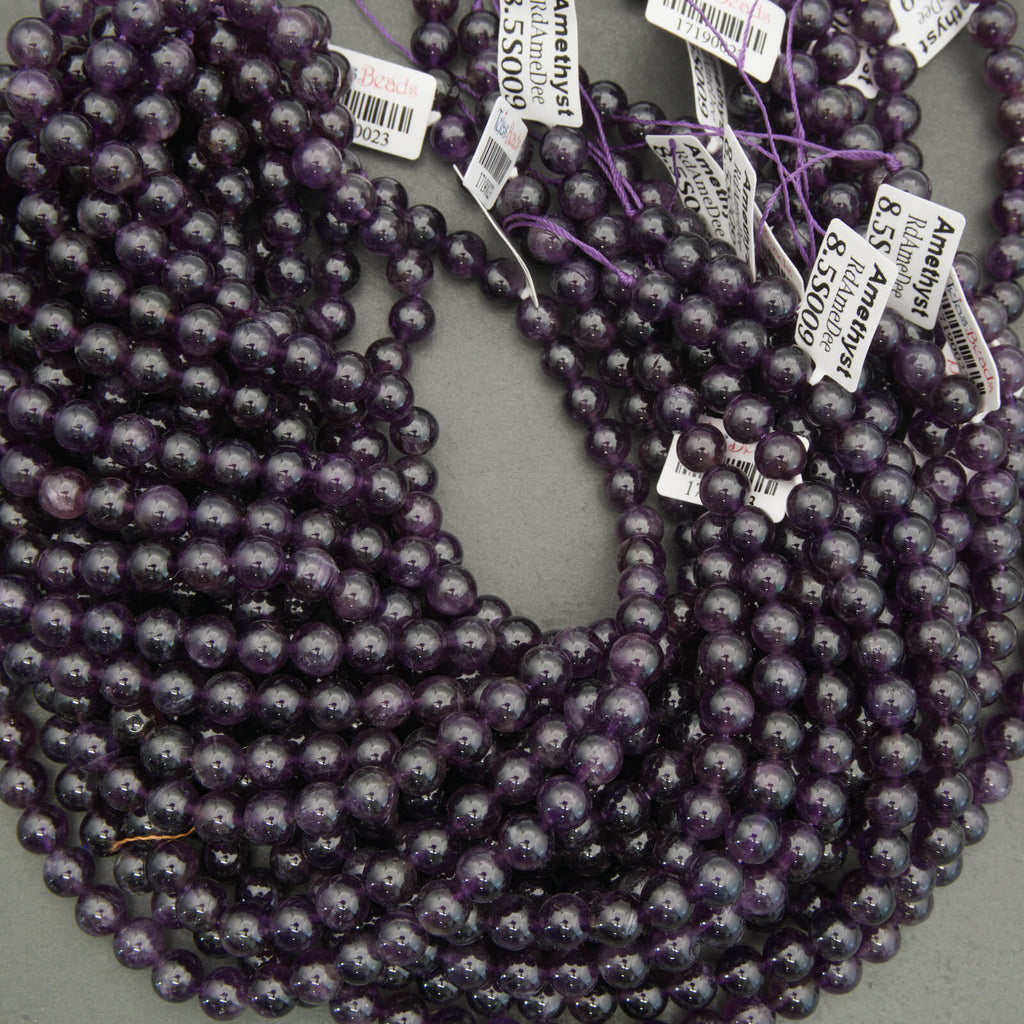 String of purple beads with price tags on a gray surface