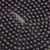 Close-up of purple beads arranged in a circular pattern