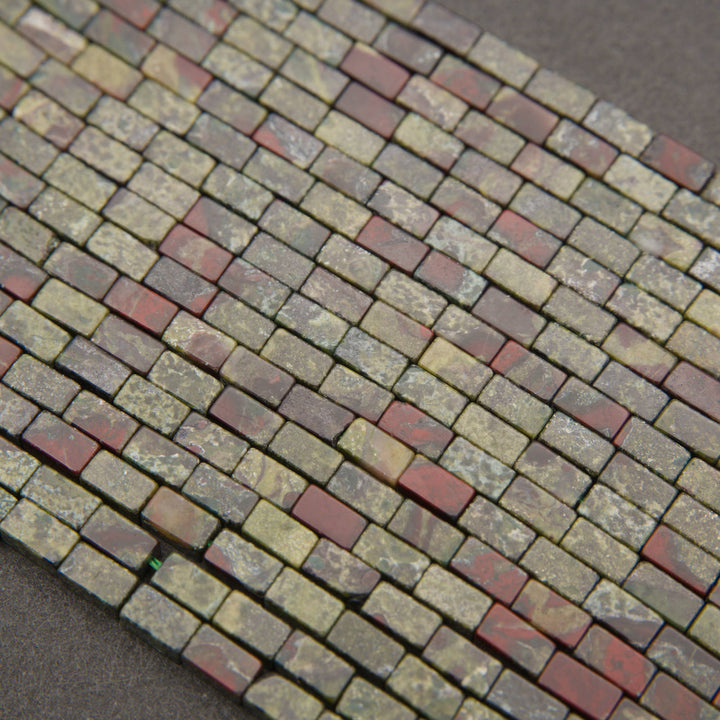 Strands of Dragon Blood Jasper rectangular tube beads with unique red and green coloration.