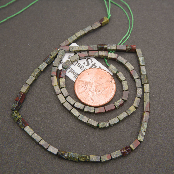 Natural Dragon Blood Jasper gemstone beads featuring earthy olive tones, deep red patches, and polished surfaces.