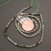 Natural Dragon Blood Jasper gemstone beads featuring earthy olive tones, deep red patches, and polished surfaces.