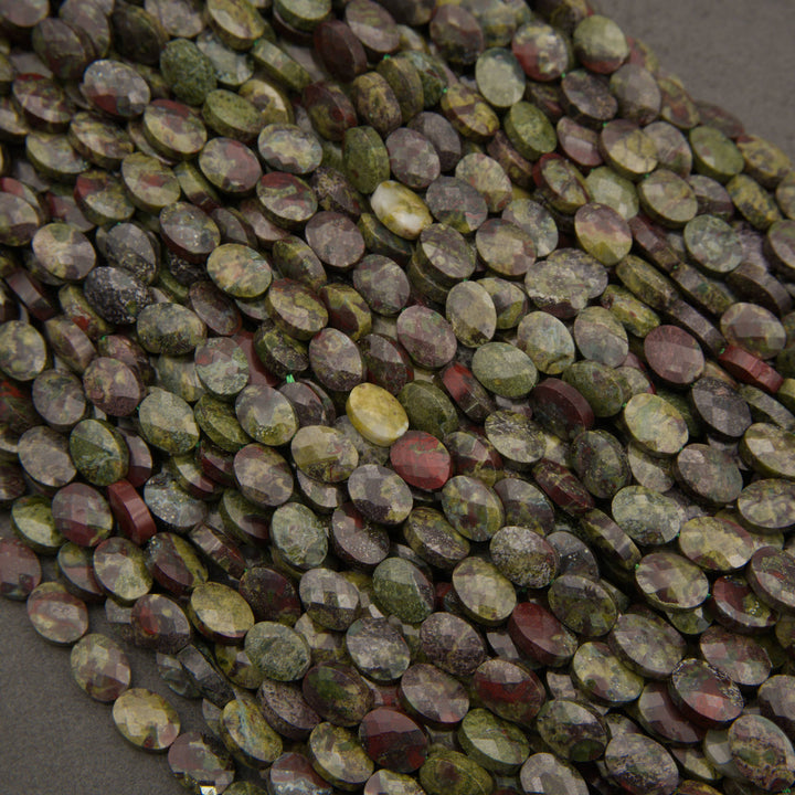 A heap of faceted dragon's blood jasper oval bead strands in mottled green and red