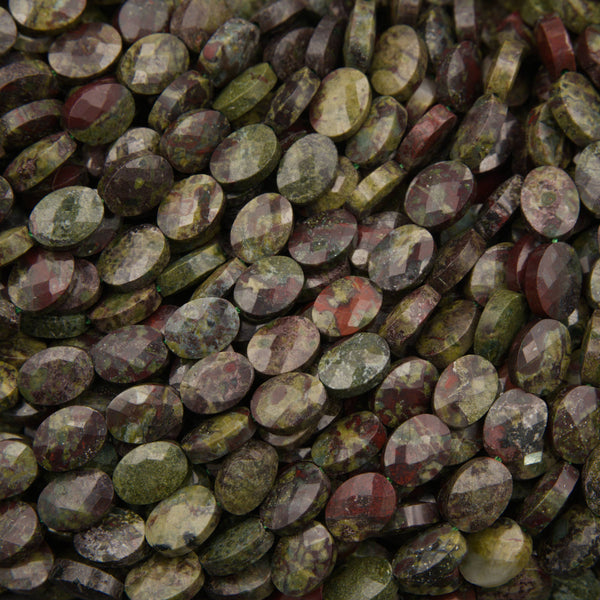 Close-up of faceted dragon's blood jasper oval beads showing green epidote with burgundy red patches
