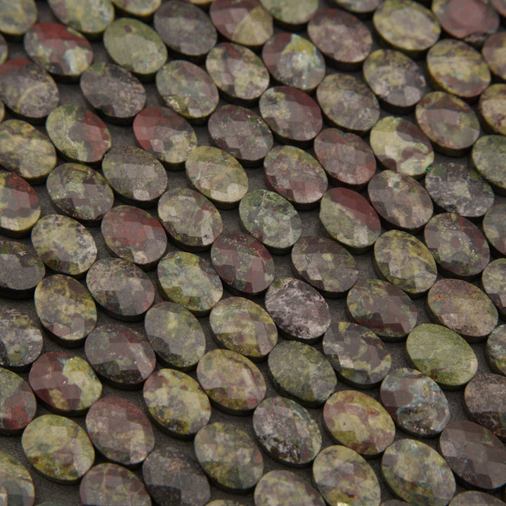 Close-up of faceted dragon's blood jasper oval beads in forest green, red and charcoal