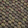Close-up of faceted dragon's blood jasper oval beads in forest green, red and charcoal