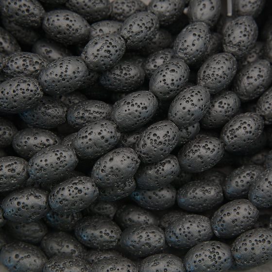 Black lava stone oval beads with a matte finish and naturally porous volcanic texture for jewelry making.
