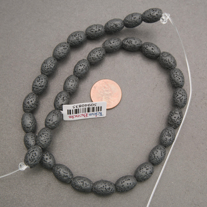 Natural black lava stone oval gemstone beads with a textured matte finish for handmade bracelets and necklaces.