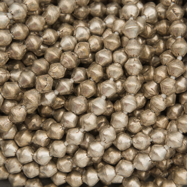 Close-up of metallic beads with a brownish color.