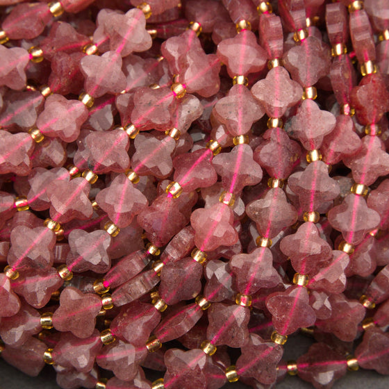 Faceted strawberry quartz clover beads in soft pink and berry tones with gold spacer beads.