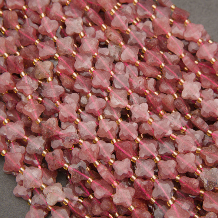 Natural strawberry quartz gemstone beads featuring four-petal floral shapes and delicate inclusions.