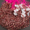 Close-up of strawberry quartz clover beads displaying dusty pink hues and natural mineral inclusions.