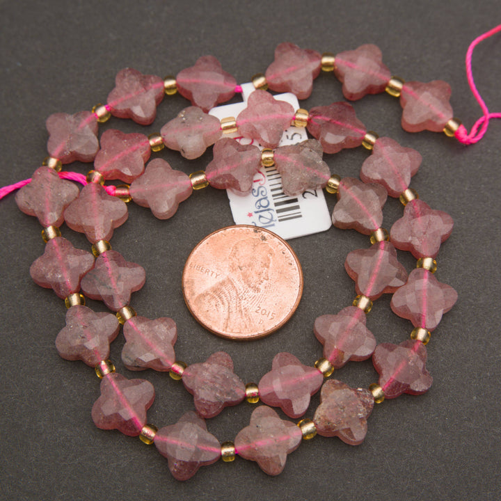 Strawberry quartz gemstone beads featuring decorative four-leaf clover shapes and softly frosted surfaces.